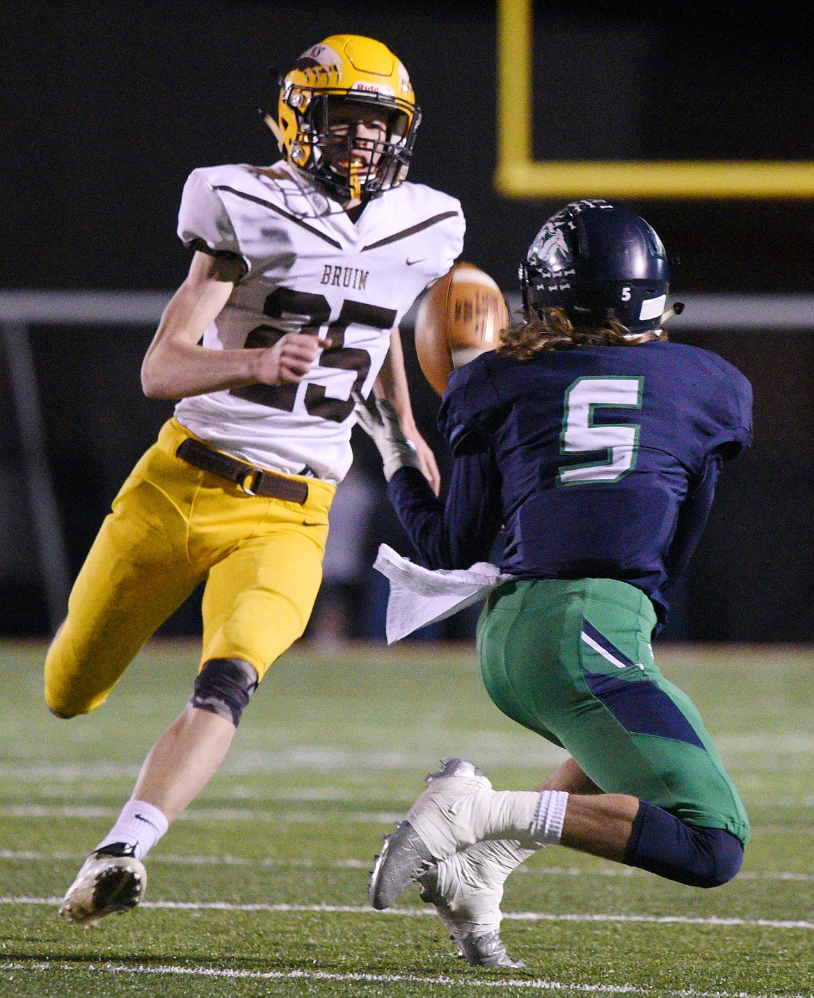 Glacier wide receiver Drew Deck (5) hauls in a reception in the third quarter in front of Helena Capital defensive back Gus Hanson at Legends Stadium on Friday. (Casey Kreider/Daily Inter Lake)