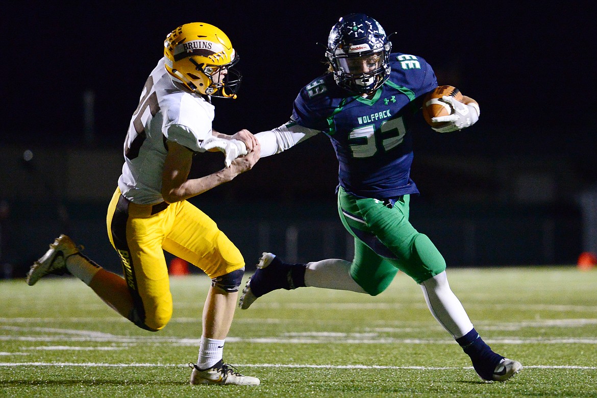 Glacier running back Preston Blain (33) gets past Helena Capital defender Gus Hanson (25) on a two-point conversion that would tie the score at 14-14 before the half at Legends Stadium on Friday. (Casey Kreider/Daily Inter Lake)