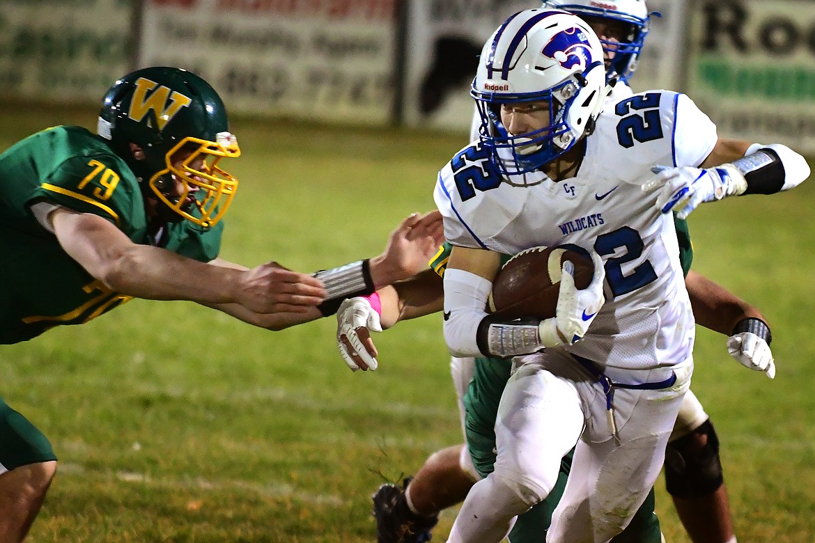 Lane Sapa makes a good gain against the Whitefish defense Friday. Sapa and the Wildcats picked up a 40-7 victory. (Jeremy Weber photo)