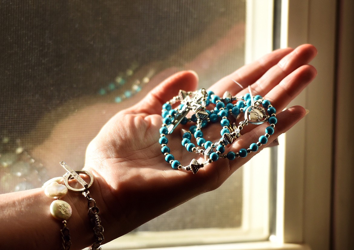 Detail of a rosary made by Katie Donahue with Miracle Beads, beads which start with a silver-finished Lucite core that is then coated with several layers of lacquer.