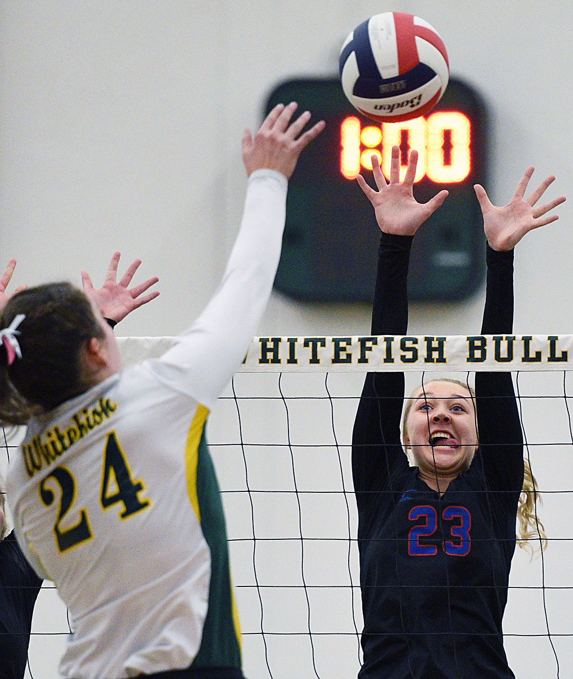 Columbia Falls' Ryley Kehr (23) goes up for a block of Whitefish's Marlee Bender (24) at Whitefish High School on Thursday. (Casey Kreider/Daily Inter Lake)