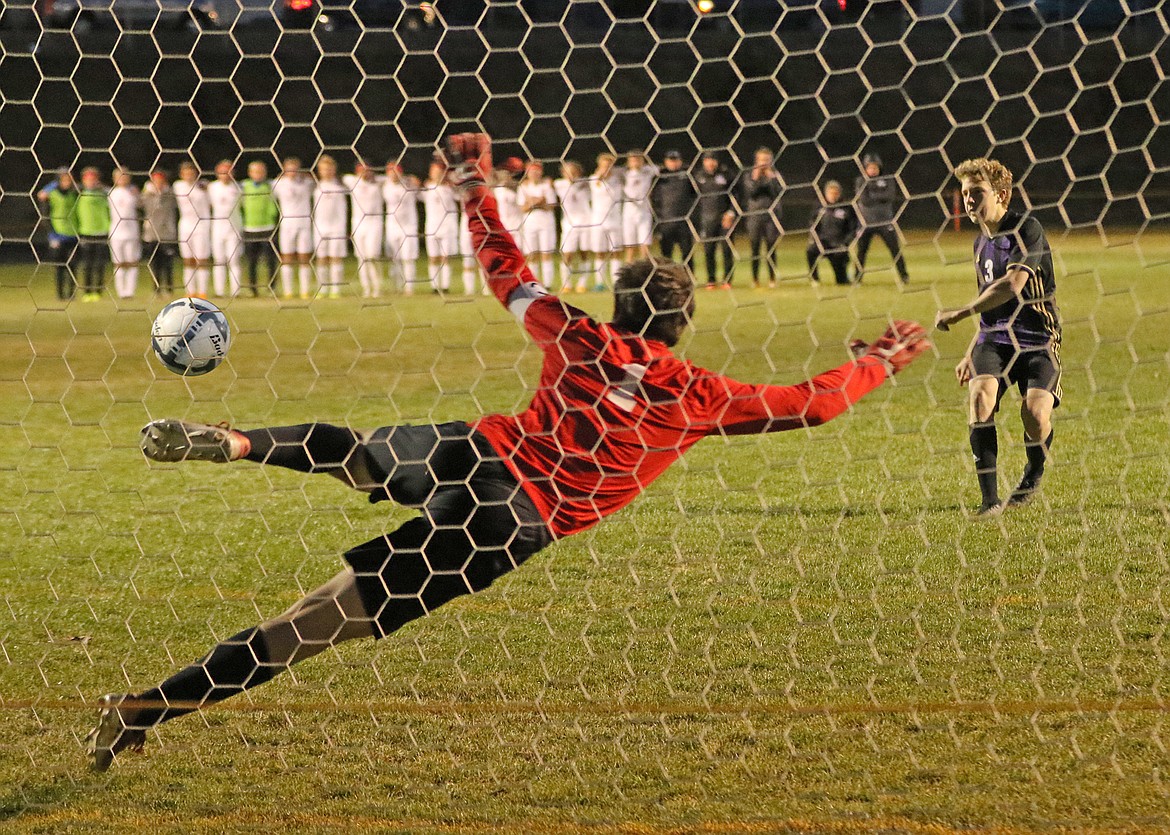 Nico River of Polson catches the Whitefish goalie leaning and booted in a shootout goal, one of six that led the Pirates to a play-in win over the Bulldogs. (Bob Gunderson/Lake County Leader)