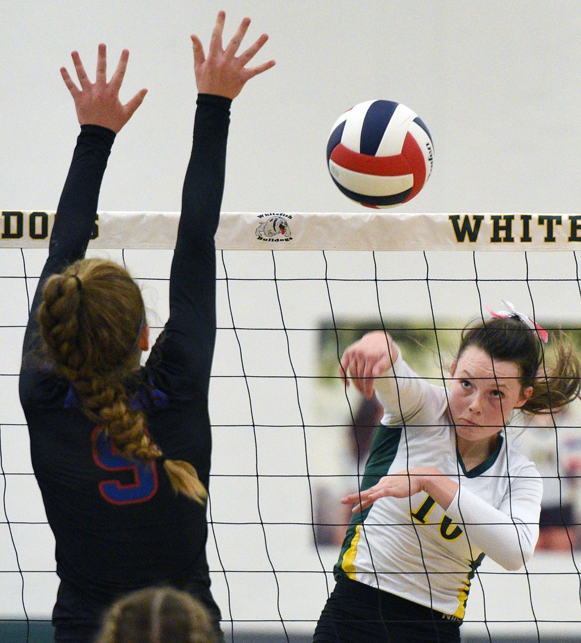 Whitefish's Kaiah Moore (10) goes for a kill against Columbia Falls' Hannah Schweikert (9) at Whitefish High School on Thursday. (Casey Kreider/Daily Inter Lake)