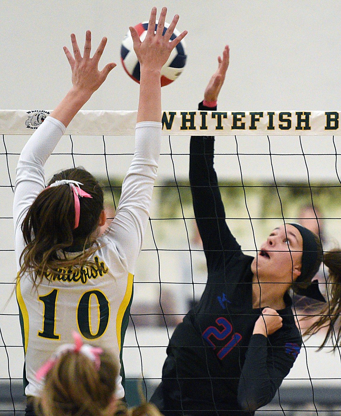 Columbia Falls' Madysen Hoerner (21) goes up for a kill against Whitefish's Kaiah Moore (10) at Whitefish High School on Thursday. (Casey Kreider/Daily Inter Lake)