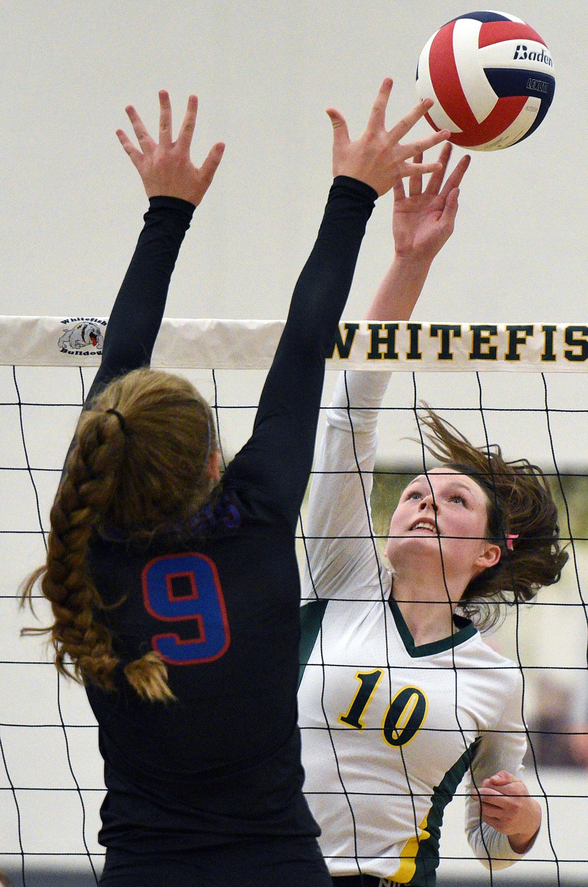 Whitefish's Kaiah Moore (10) goes for a kill against Columbia Falls' Hannah Schweikert (9) at Whitefish High School on Thursday. (Casey Kreider/Daily Inter Lake)