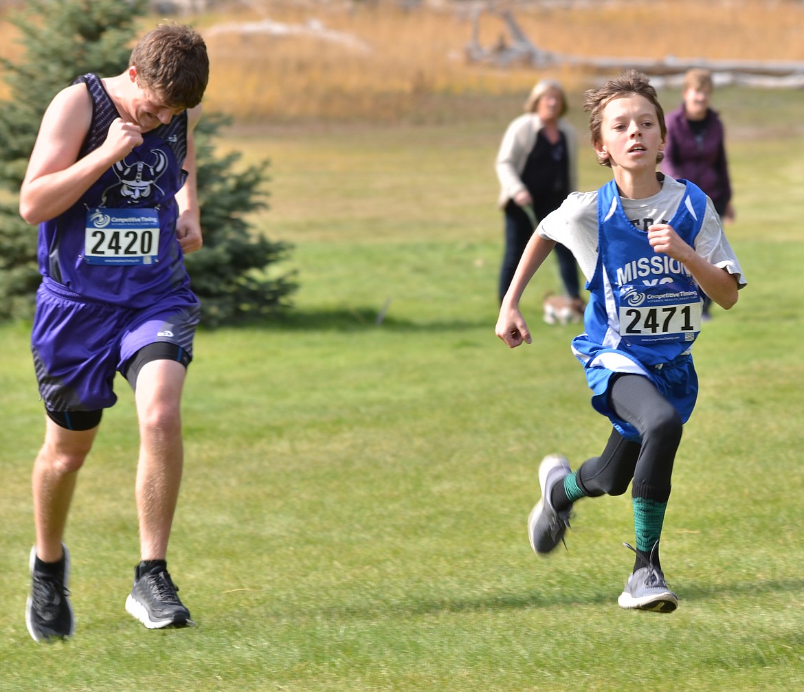 Mission runner Kody Dillard sprints to the finish line past Nate Delaney of Charlo during the Class B-C Western Divisional meet at Thompson Falls. (Erin Jusseaume/Clark Fork Valley Press)