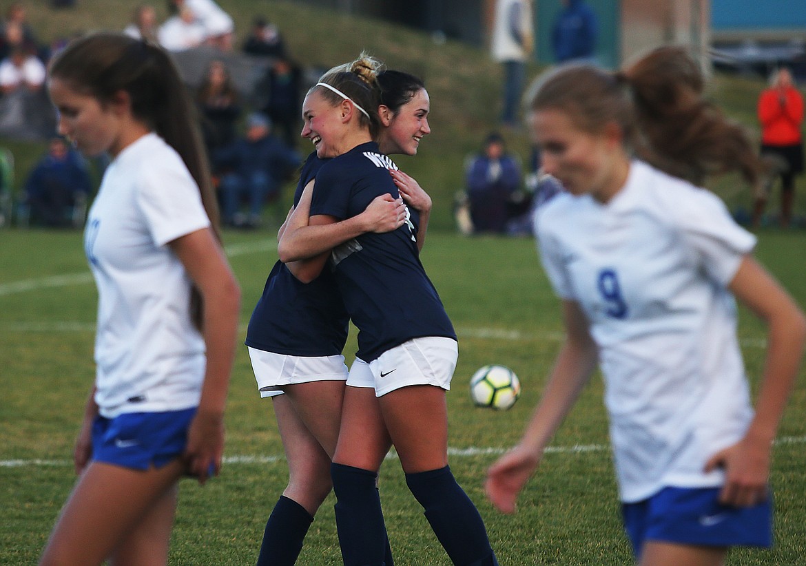 LOREN BENOIT/Press
Lake City&#146;s Sydney Harbison and Chloe Teets celebrate their team&#146;s 3-0 win over the Coeur d&#146;Alene Vikings in the Region 1 girls soccer championship game on Tuesday at Lake City High School.