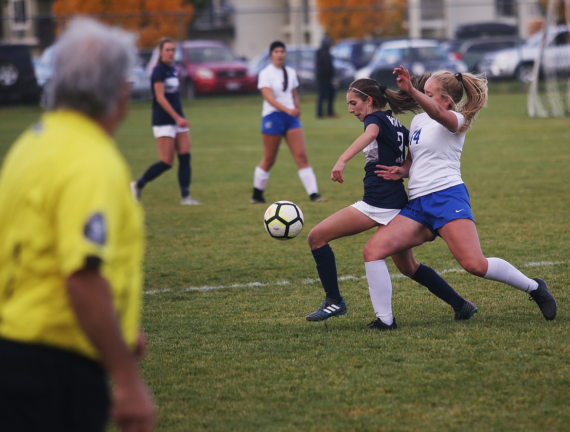 Lake City's Madyson Smith (3) and Coeur d'Alene's Julie Stith (14) battle for the soccer ball near midfield in Tuesday's Region 1 girls soccer championship game at Lake City High School. (LOREN BENOIT/Press)