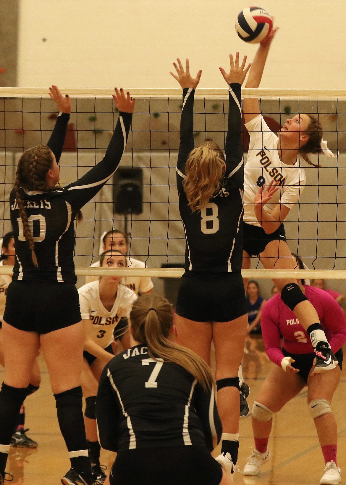 Polson sophomore Maggie Todd drills the ball past an attempted block by Sarah Nalls (10) and Prestley Robinson (8) of Stevensville during last Thursday&#146;s home match. The Yellow Jackets won the match. (Bob Gunderson/Lake County Leader)