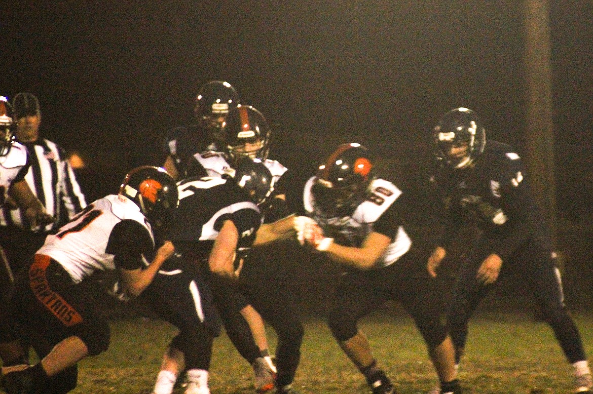 Photo by TANNA YEOUMANS
Bonners Ferry quarterback Aaron Scott fights for yardage as the Priest River defense converges during Friday&#146;s homecoming game against the Spartans.