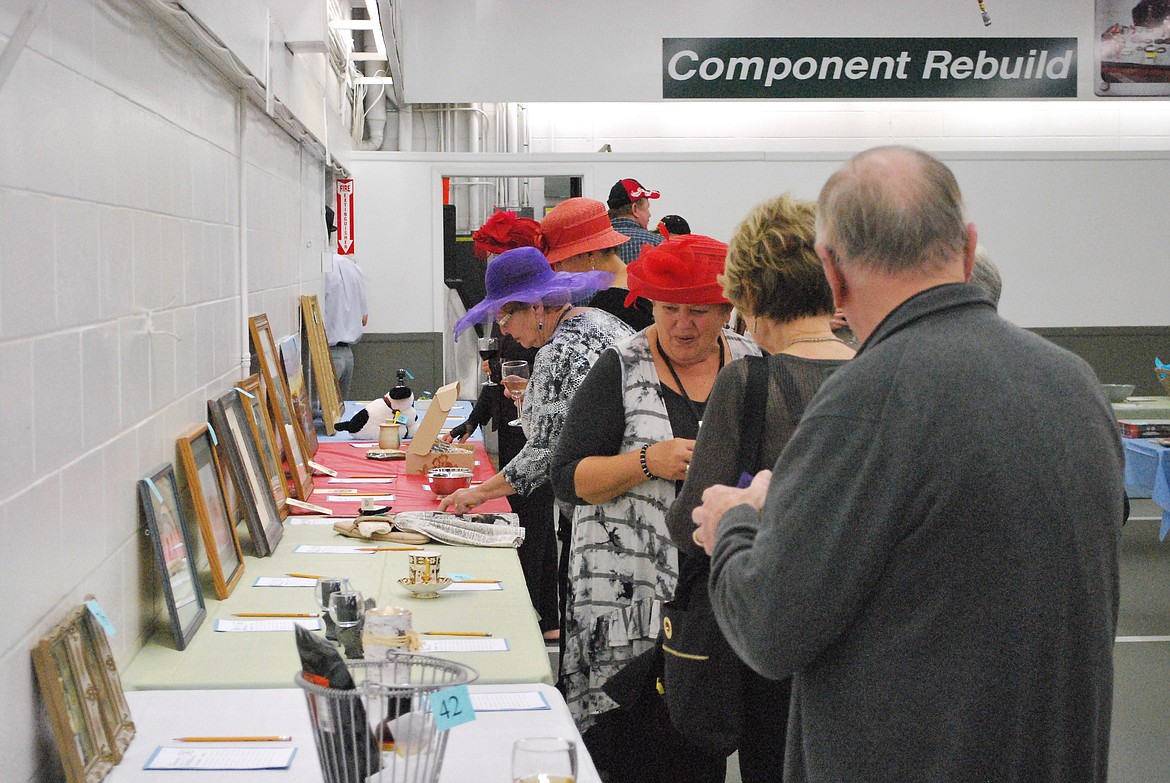 File photo - Attendees at the fundraiser check out the items up for bid in last year's silent auction. This year's event is Saturday.