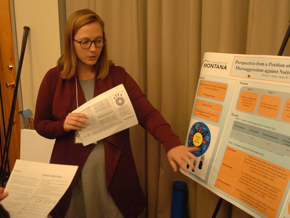 Olivia Holter explains the poster she constructed during a University of Montana project and exhibited during the American Indigenous Research Association last weekend. (Joe Sova/Lake County Leader)