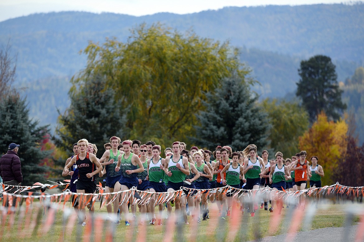 Flathead's Ben Perrin, left, takes an early lead in the Glacier Invitational cross-country race at Rebecca Farm on Wednesday. (Casey Kreider/Daily Inter Lake)