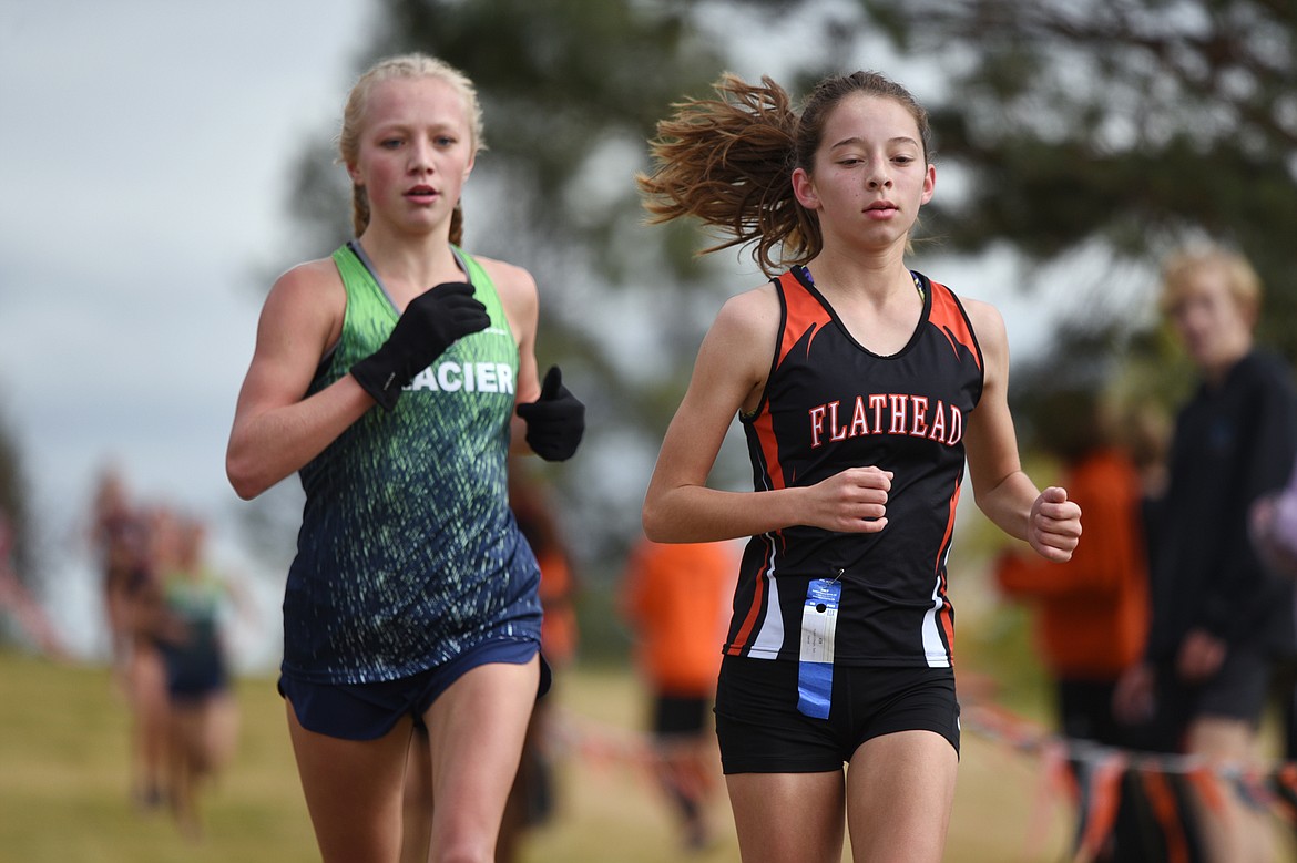 Flathead's Tori Noland-Gillespie, right, leads Glacier's Kinzie Peterson near the halfway point at the Glacier Invitational cross-country race at Rebecca Farm on Wednesday. (Casey Kreider/Daily Inter Lake)