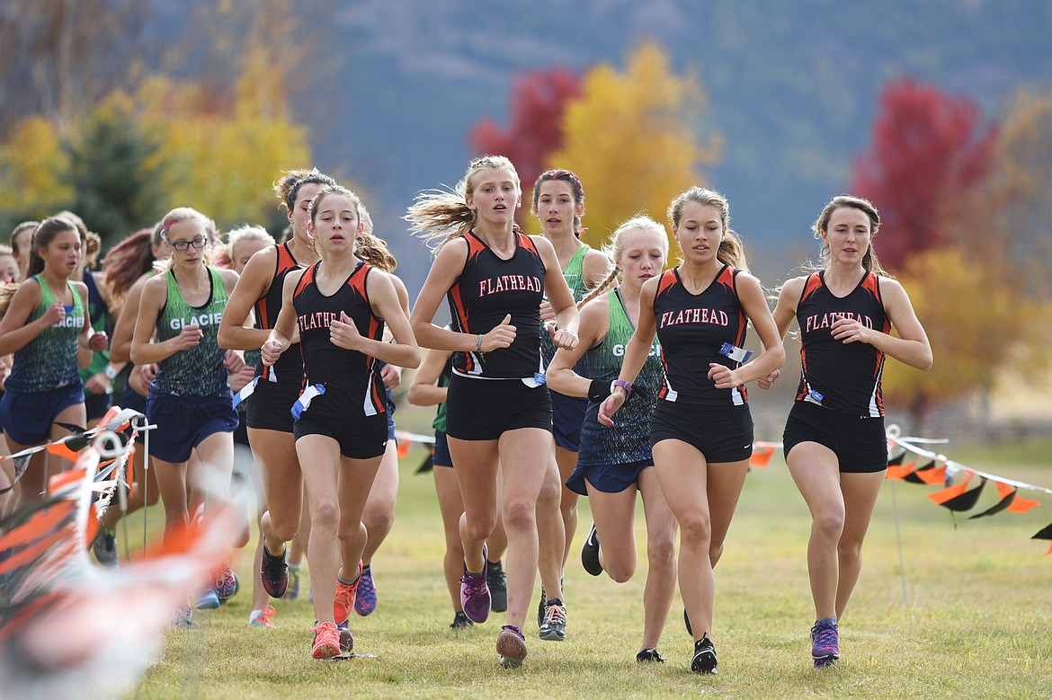 Flathead girls take the lead around the first bend at the Glacier Invitational cross-country race at Rebecca Farm on Wednesday. (Casey Kreider/Daily Inter Lake)