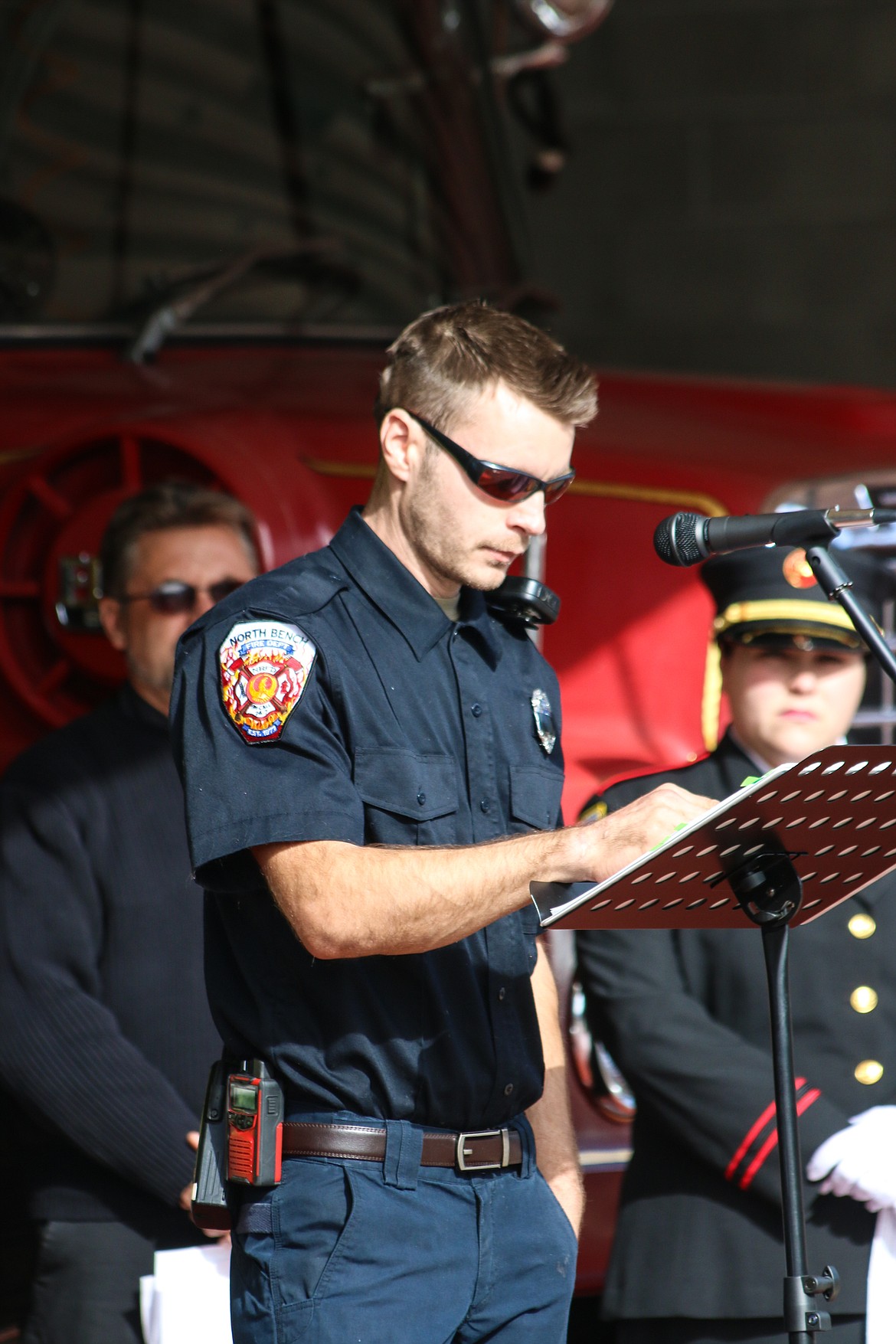 Photo by MANDI BATEMAN
Fire personnel from different agencies took turns reading from the long list of names.