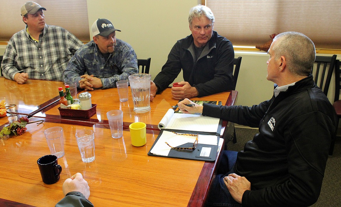 From left to right, Tim McEntire, Montana Logging Association; Ed Jungers, J. &amp; E. Contracting; and Kevin Cotton, Titan Machinery, talk with Matt Rosendale, Republican candidate for U.S. Senate, Tuesday in Kalispell. (Duncan Adams/Daily Inter Lake)