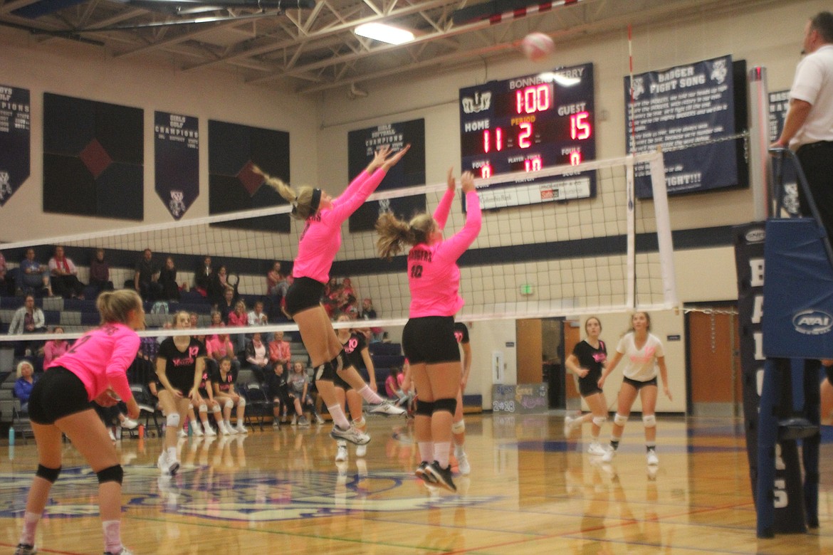 Jerzie Pluid jumps for the block during the Dig Pink game.