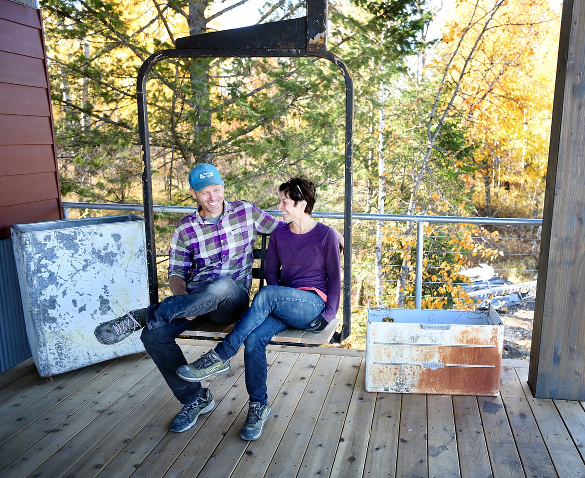 Jake Christiansen and Yvonne May sitting in the reclaimed ski lift chair on the porch of their new home in Whitefish on Monday, October 8.(Brenda Ahearn/Daily Inter Lake)