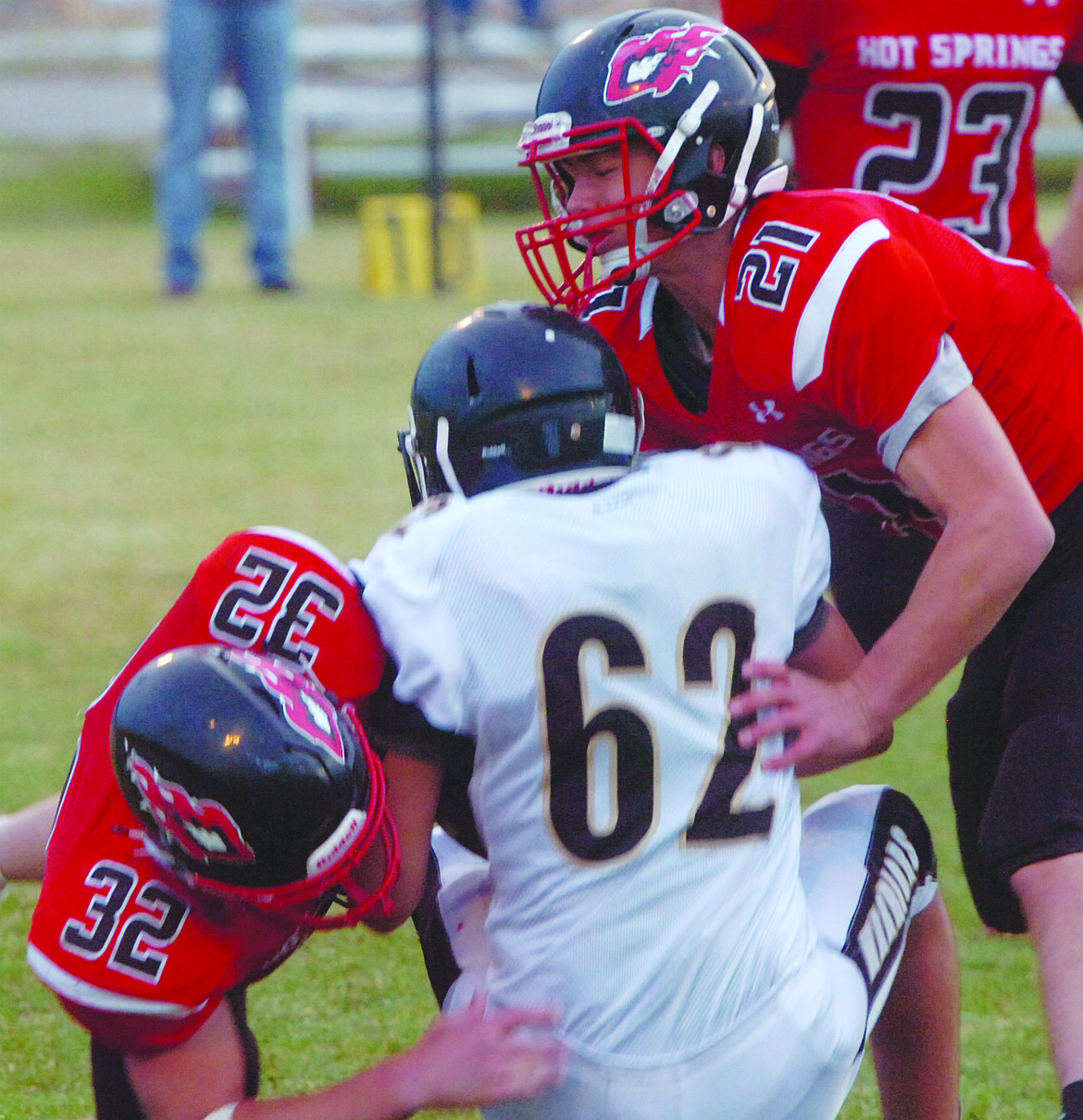 Hot Springs seniors, Tyler Carr (21) and Tyler Knudsen (32), team up to tackle Clifftin Bullshoe of Heart Butte during the Savage Heat&#146;s Homecoming game. Hot Springs scored five times in the opening quarter en route to a 50-7 victory. (Joe Sova/Clark Fork Valley Press)