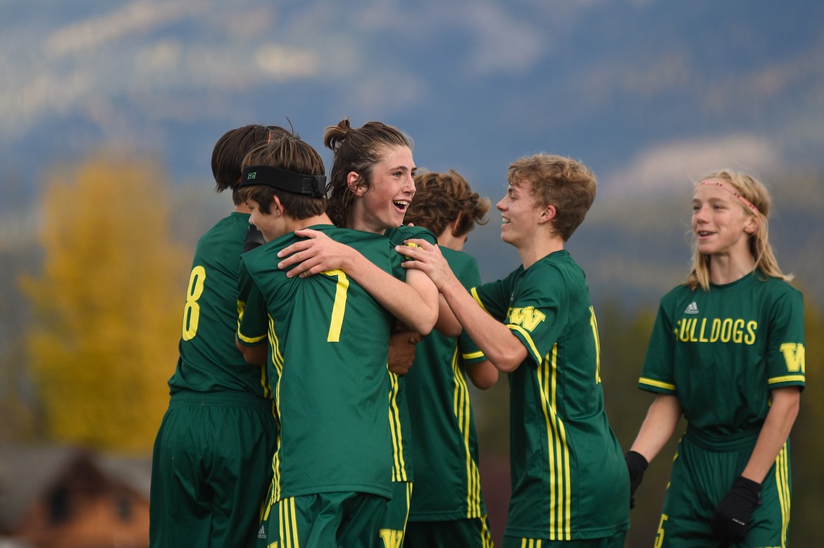 James Thompson receives a pat on the back from his teammates after a goal in Saturday's quarterfinal match against Livingston-Park.