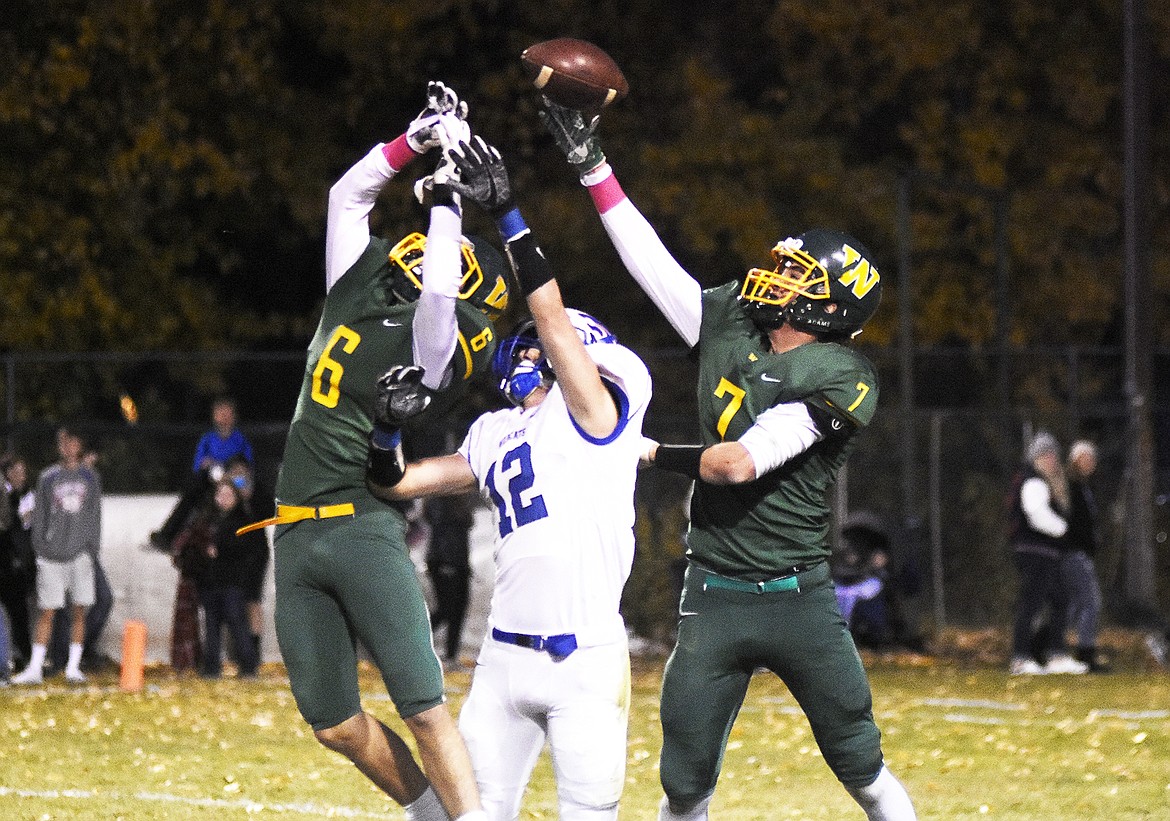 Jack Eisenbarth and Carver Gilman tip a Columbia Falls pass last Friday. (Daniel McKay photos/Whitefish Pilot)