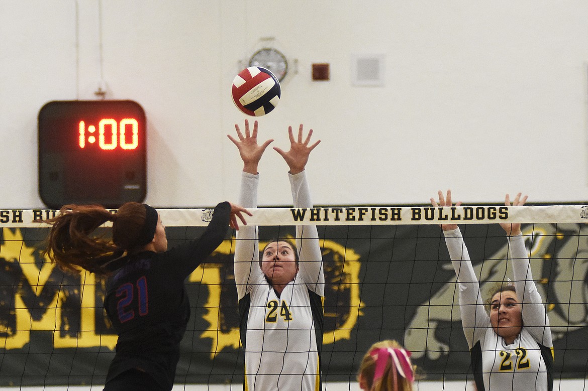 Marlee Bender and Luci Ridgeway rise up for the block during a 3-2 loss to Columbia Falls last week.