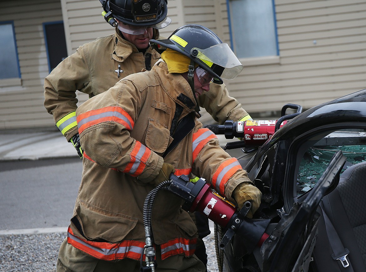 Coeur d'Alene Press reporter Brian Walker uses the jaws of life during a vehicle extrication scenario at Coeur d'Alene Fire Department's media day event last Thursday. (LOREN BENOIT/Press)