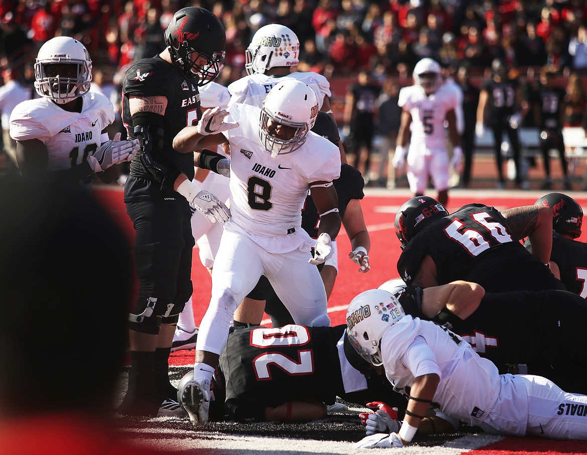 University of Idaho linebacker Tre Walker celebrates after tackling Eastern Washington University running back Sam McPherson for a loss in Saturday's game at Pacific Roos Field in Cheney. (LOREN BENOIT/Press)