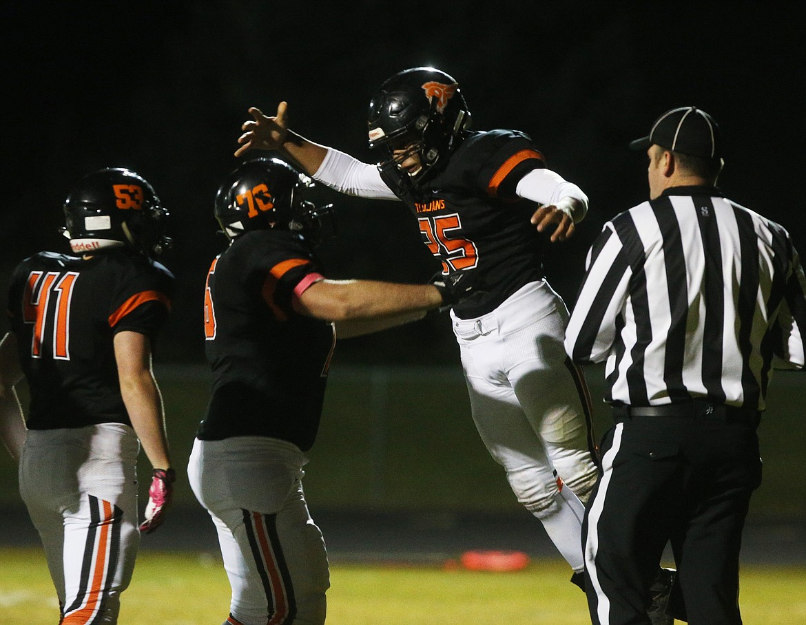 Post Falls running back Eli Gondo celebrates his rushing touchdown with Austin Tipton (76) and Cameron Sessions in Friday night&#146;s first round playoff game against Skyview. (LOREN BENOIT/Press)
