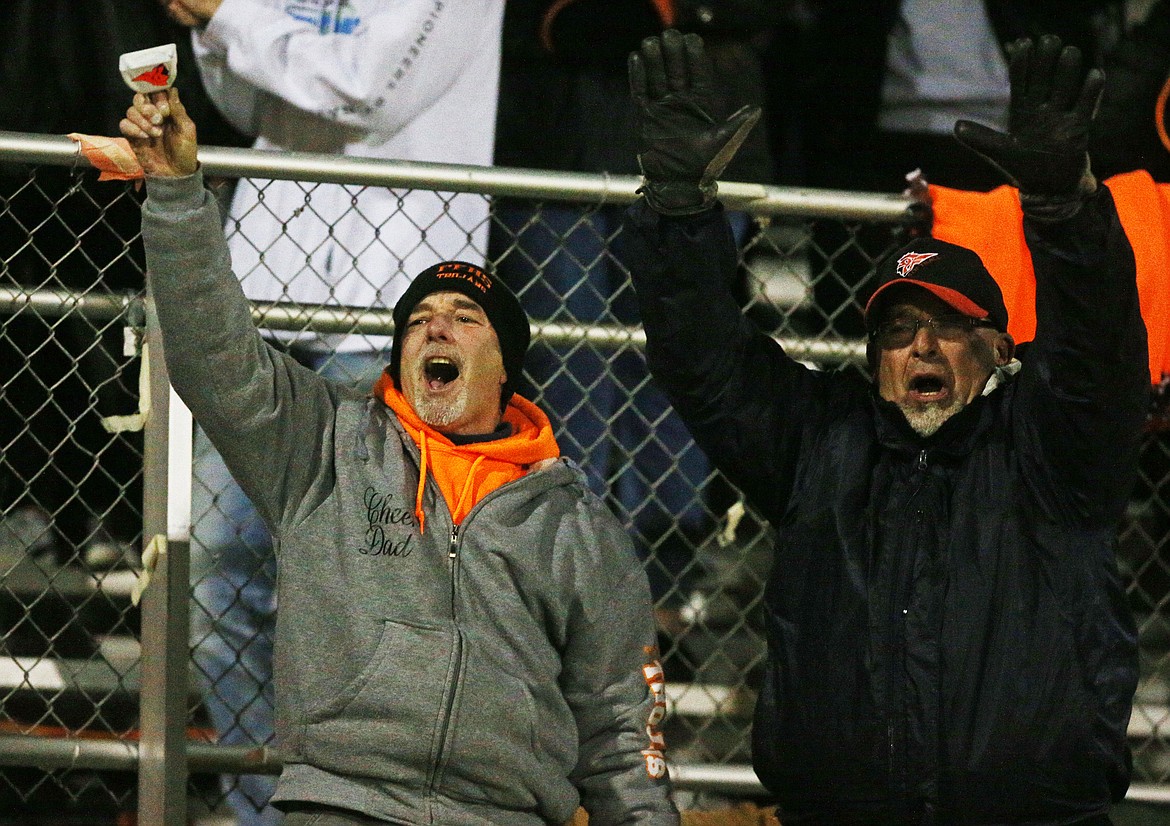 Two Post Falls fans celebrate a Trojan touchdown in the final seconds of Friday night&#146;s first round playoff game against Skyview.  To read full story, see B1. (LOREN BENOIT/Press)