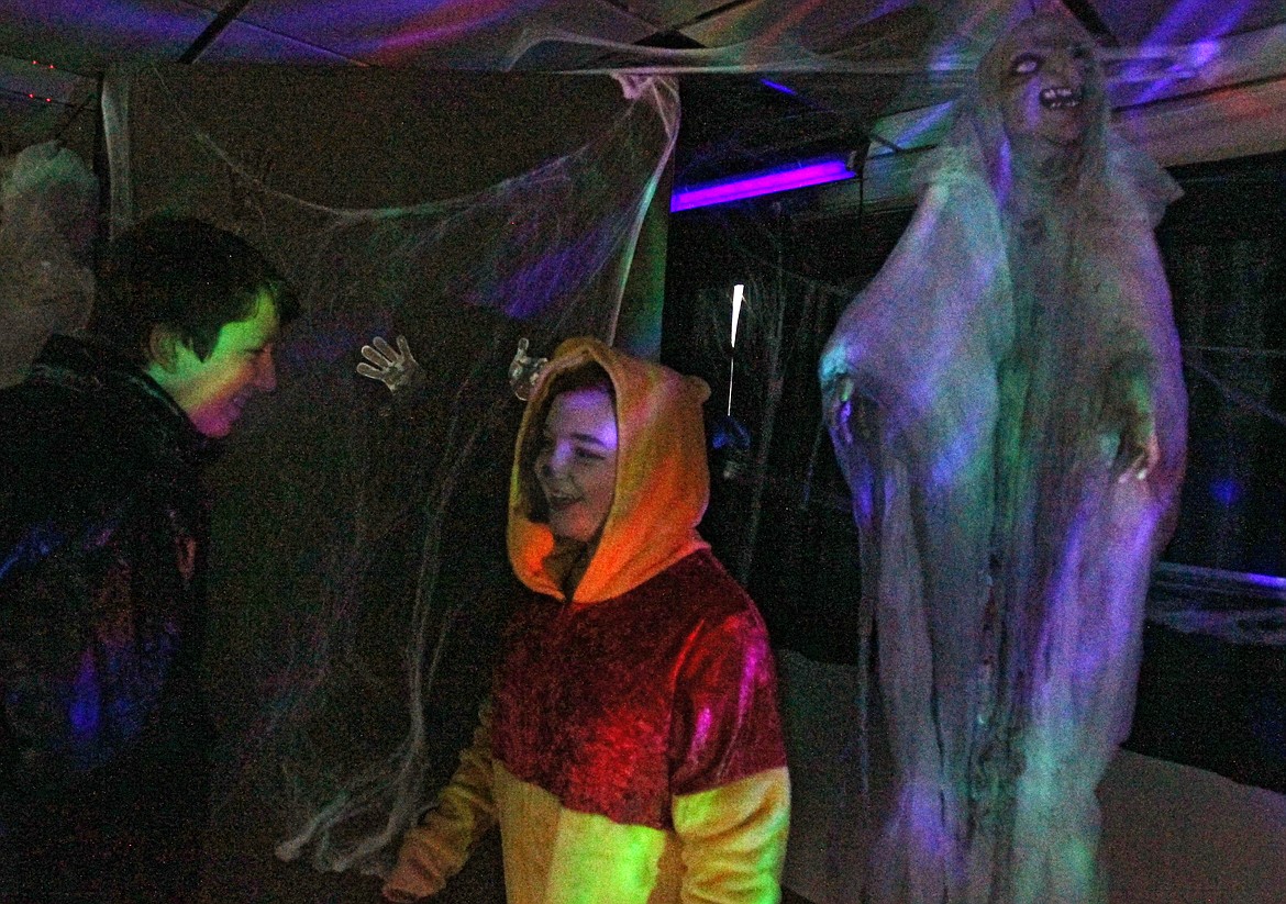 Halia Bruce, 13, in her Winnie the Pooh costume, and her cousin Andrew Pielli, 13, as Christopher Robin, have a laugh Thursday evening as they exit the haunted house onboard the Moonlit Monster Cruise on Lake Coeur d&#146;Alene. The cruises are family-friendly and for all ages. (DEVIN WEEKS/Press)