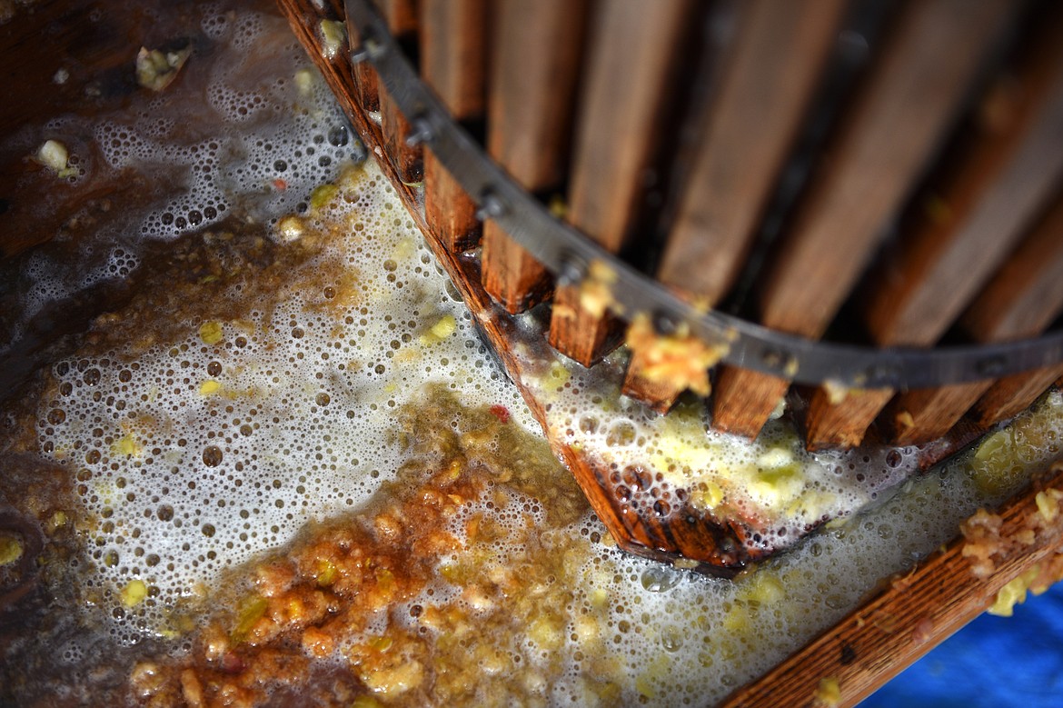 Bits of apple and unpasteurized cider are squeezed from the press at Apple Barrel Country Market on Thursday. (Casey Kreider/Daily Inter Lake)