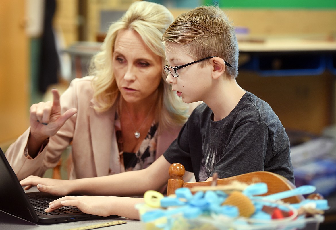 Teacher Shelley Emslie helps Logan Pajnich which his Google Chromebook during class on Tuesday, Oct. 23, at Swan River School. Emslie has been working to develop a 3-D curriculum across grade levels. Students in second grade through sixth are learning to use the technology. Swan River School was a recent recipient of a new 3-D printer through a MontanaPBS grant to support teachers in rural schools to use the latest technology in the classroom. (Brenda Ahearn/Daily Inter Lake)