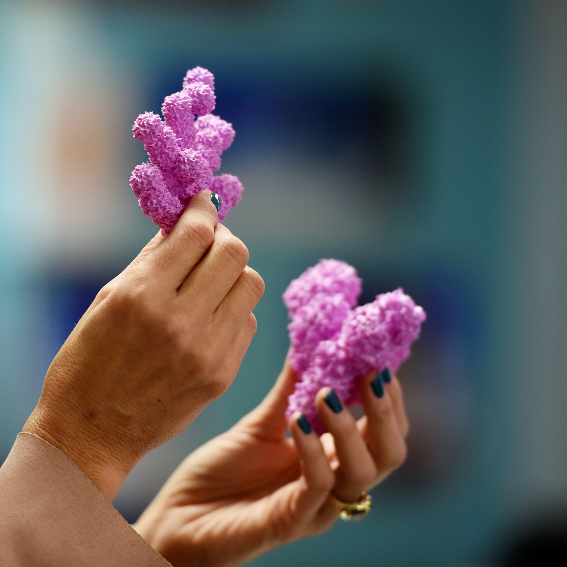 Shelley Emslie displays examples of 3-D-printed coral reef pieces.