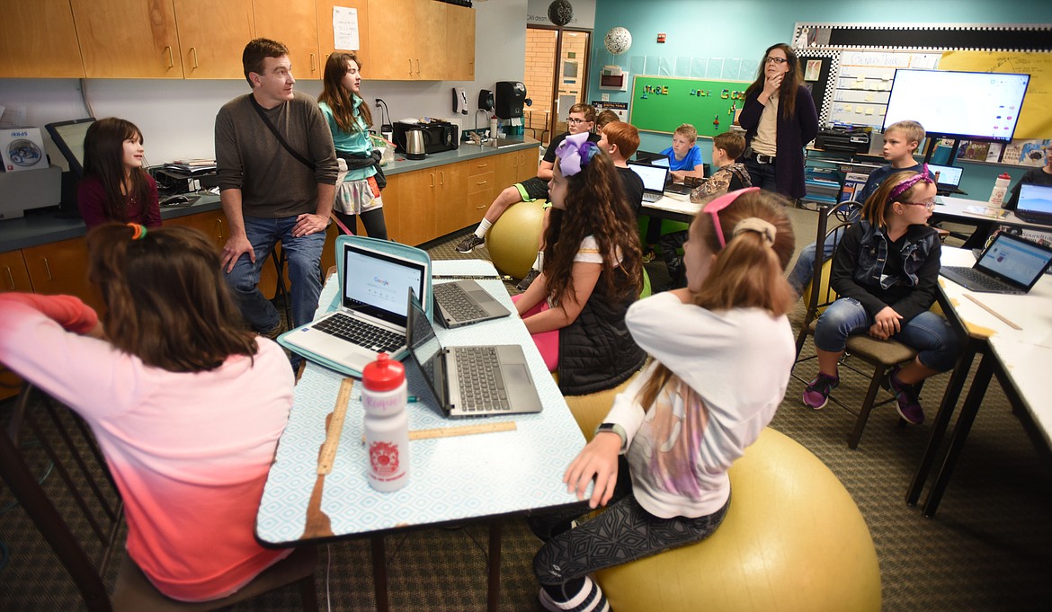 Parent volunteers Eric and Cyndy Thorsen talk to students about 3-D printing in Shelley Emslie&#146;s fifth-grade class on Tuesday, Oct. 23, at Swan River School. Eric Thorsen is an artist who designs bronze sculptures using 3-D printing technology. Cyndy Thorsen manages the Bigfork gallery where his work is displayed. (Brenda Ahearn/Daily Inter Lake)