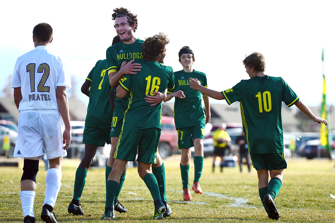 Whitefish's Sam Menicke (20) celebrates with Xander Burger (16) after Burger's second of five goals against Polson in the Class A state soccer championship at Smith Fields in Whitefish on Saturday. Whitefish won, 6-2. (Casey Kreider/Daily Inter Lake)