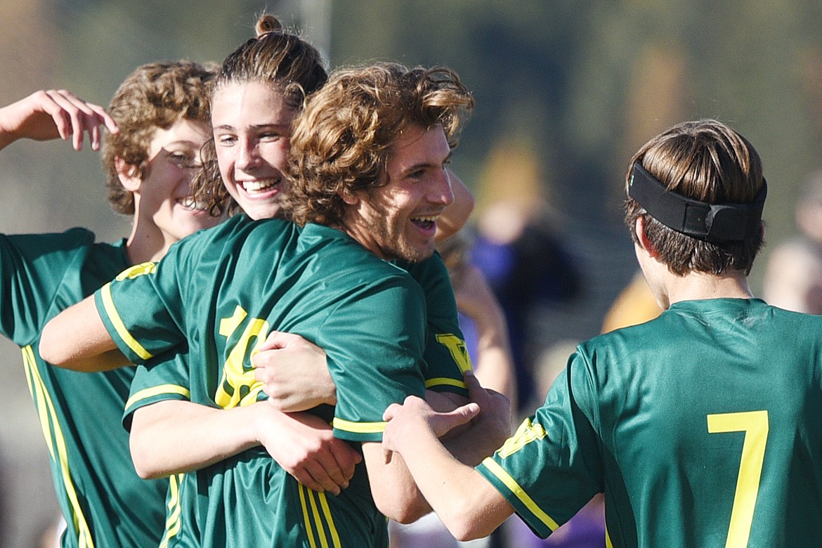 From left, Whitefish's Gabe Menicke (9), James Thompson (17), Xander Burger (16) and Ian Lacey (7) celebrate after Burger's third of five goals against Polson in the Class A state soccer championship at Smith Fields in Whitefish on Saturday. Whitefish won, 6-2. (Casey Kreider/Daily Inter Lake)