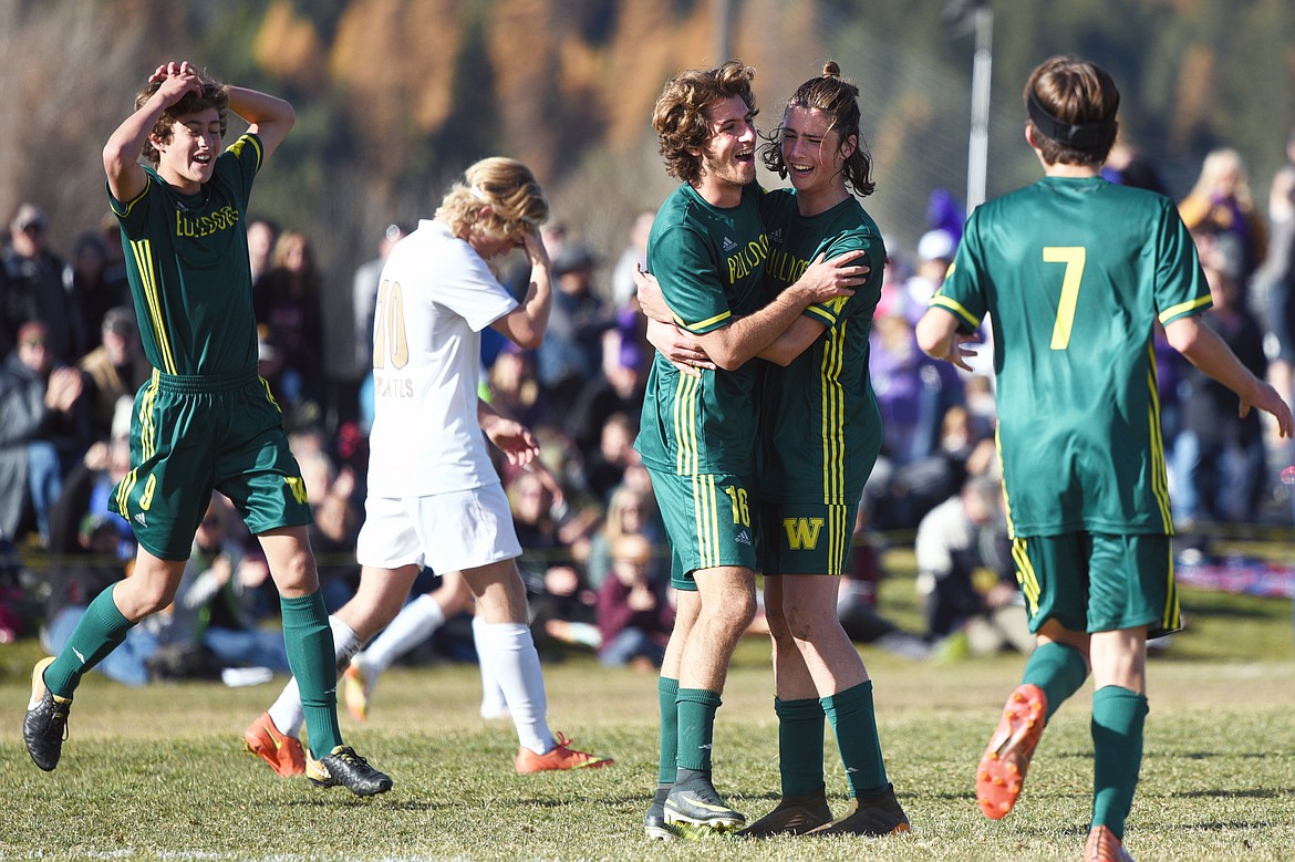 Whitefish's Xander Burger (16) celebrates with James Thompson (17) after Burger's third of five goals against Polson in the Class A state soccer championship at Smith Fields in Whitefish on Saturday. Whitefish won, 6-2. (Casey Kreider/Daily Inter Lake)