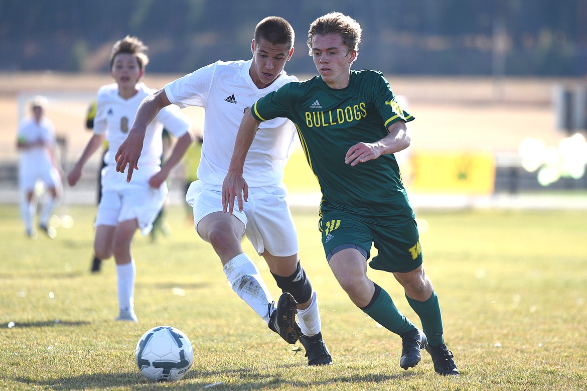 Whitefish's Casey Schneider (10) pushes the ball upfield against Polson's Austin Luper (12) during the Class A state soccer championship at Smith Fields in Whitefish on Saturday. Whitefish won, 6-2. (Casey Kreider/Daily Inter Lake)