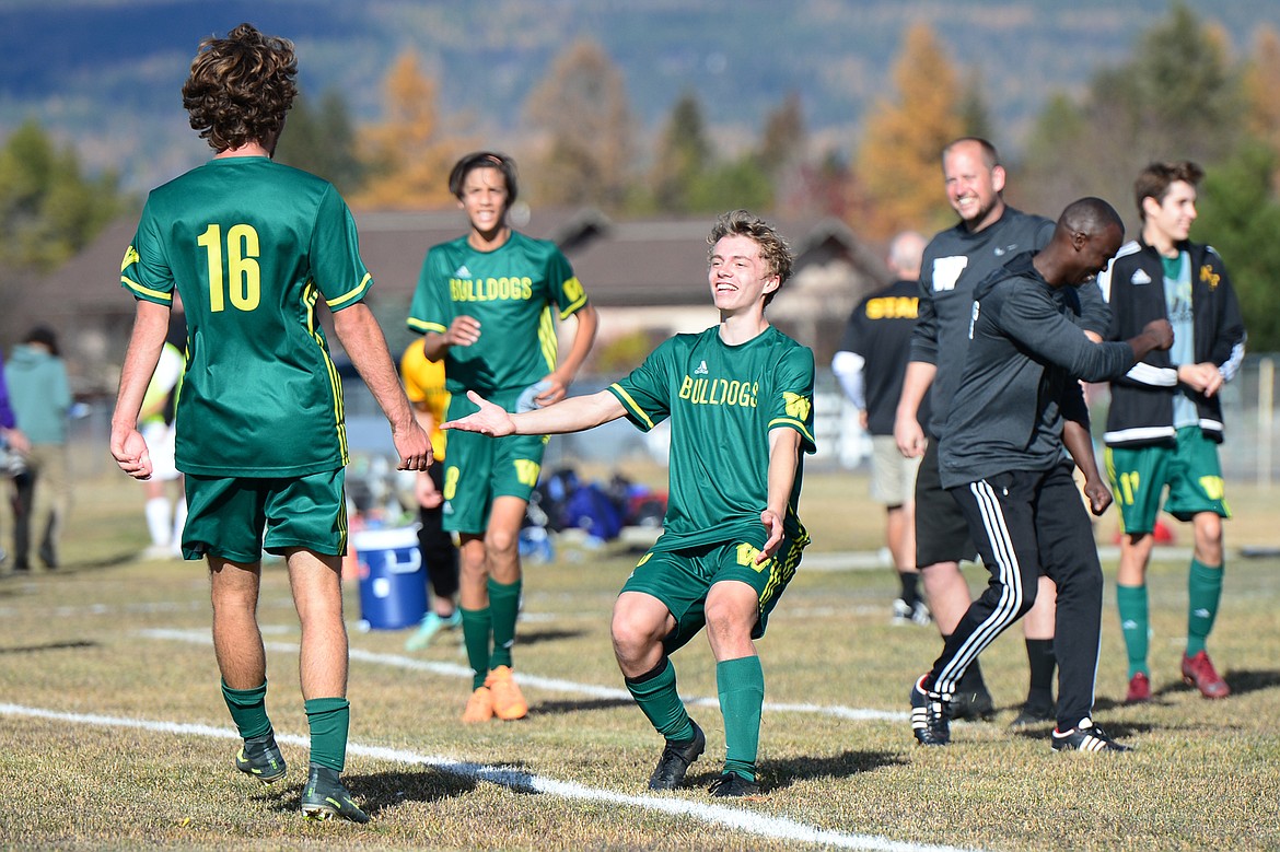 Whitefish's Xander Burger (16) heads over to the sideline to celebrate with Casey Schneider (10) after Burger's fifth goal in the Class A state soccer championship against Polson at Smith Fields in Whitefish on Saturday. (Casey Kreider/Daily Inter Lake)