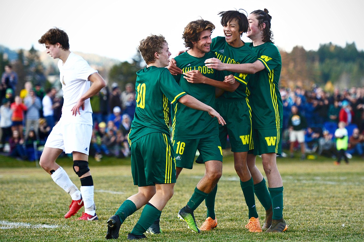 From left, Whitefish's Casey Schneider (10), Xander Burger (16), Brandon Mendoza (8) and James Thompson (17) celebrate after Burger's fourth goal of the game in the Class A state soccer championship against Polson at Smith Fields in Whitefish on Saturday. Whitefish won, 6-2. (Casey Kreider/Daily Inter Lake)