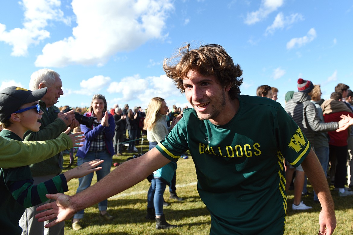 Whitefish's Xander Burger (16) celebrates with fans after his five-goal performance in the Bulldogs' 6-2 victory over Polson in the Class A state soccer championship at Smith Fields in Whitefish on Saturday. (Casey Kreider/Daily Inter Lake)