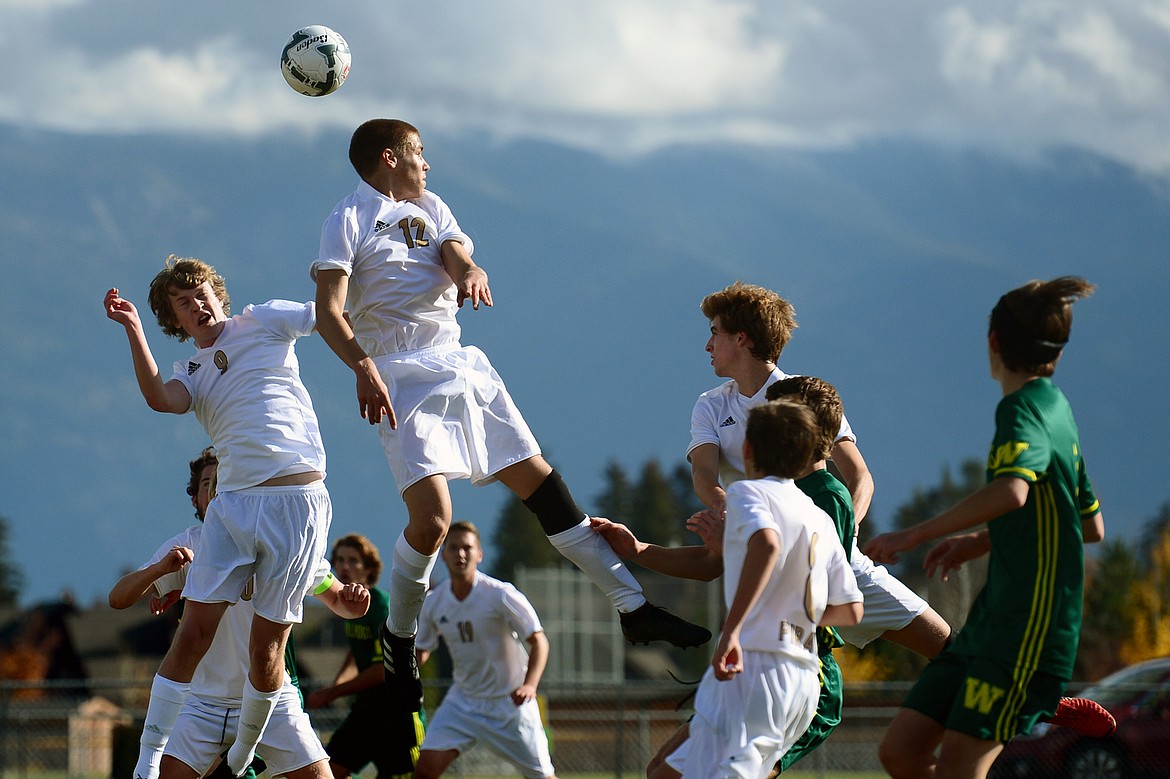 Polson's Connor Lanier (9) and Austin Luper (12) head a Whitefish corner kick out of the box in the first half of the Class A state soccer championship at Smith Fields in Whitefish on Saturday. Whitefish won, 6-2. (Casey Kreider/Daily Inter Lake)