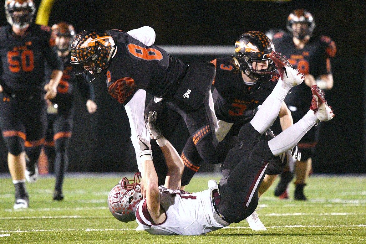 Flathead's Anthony Jones (8) is brought down by Helena defensive back Zachary Spiroff (14) after a third-quarter reception at Legends Stadium on Friday. (Casey Kreider/Daily Inter Lake)