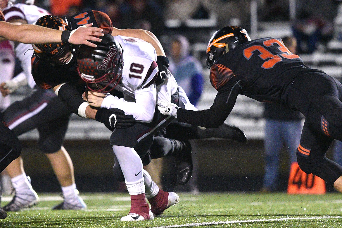 Helena quarterback Ty McGurran (10) is sacked by Flathead linebacker Tanner Russell (44) in the third quarter at Legends Stadium on Friday. Assisting on the play is Flathead linebacker Paxton Boyce (33). (Casey Kreider/Daily Inter Lake)