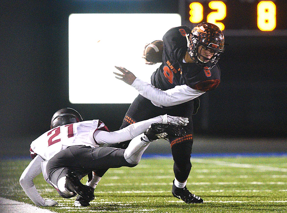 Flathead's Anthony Jones (8) breaks the tackle of Helena's David Lowry (21) after a third-quarter reception at Legends Stadium on Friday. (Casey Kreider/Daily Inter Lake)