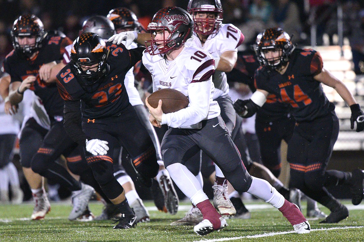 Helena quarterback Ty McGurran (10) gets to the outside for a gain against Flathead at Legends Stadium on Friday. (Casey Kreider/Daily Inter Lake)