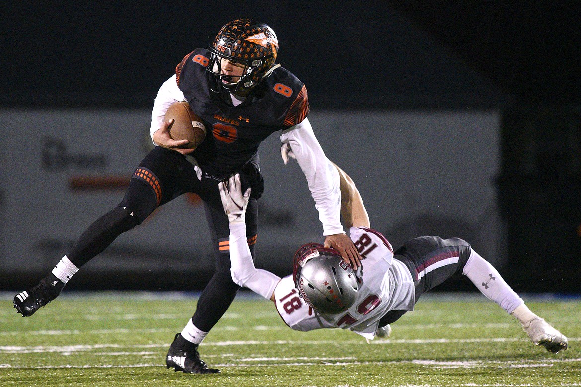 Flathead's Anthony Jones (8) stiff-arms Helena's Cooper Biegler (18) after a third-quarter reception at Legends Stadium on Friday. (Casey Kreider/Daily Inter Lake)