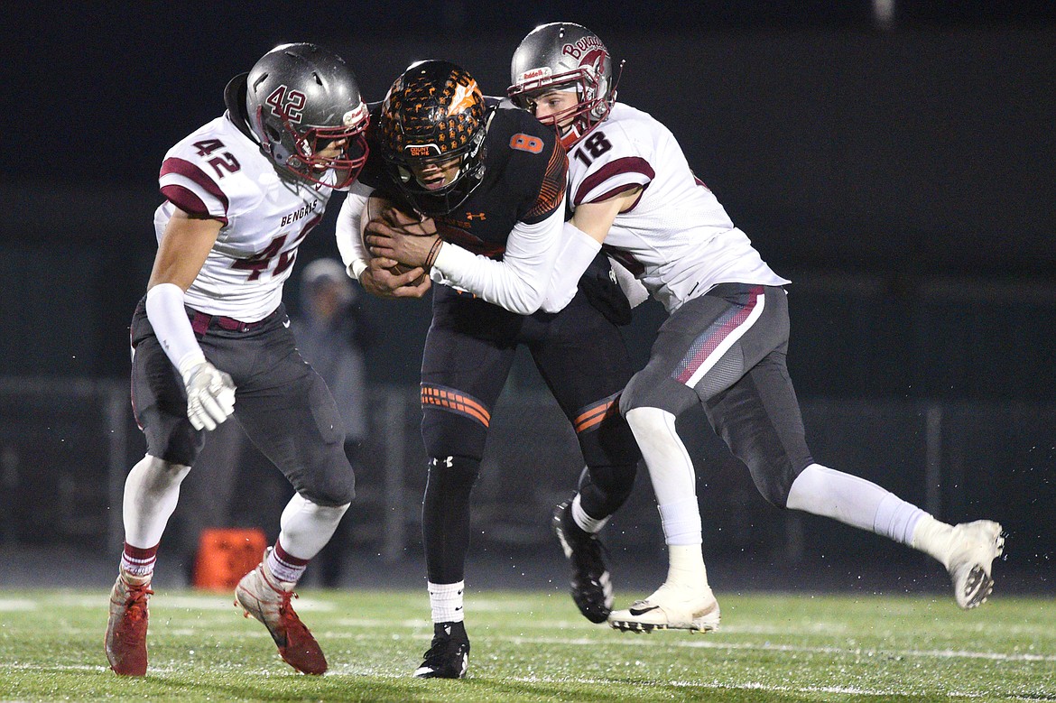 Flathead's Anthony Jones (8) is brought down by Helena defenders Samuel Shepherd (42) and Cooper Biegler (18) after a first-quarter reception at Legends Stadium on Friday. (Casey Kreider/Daily Inter Lake)